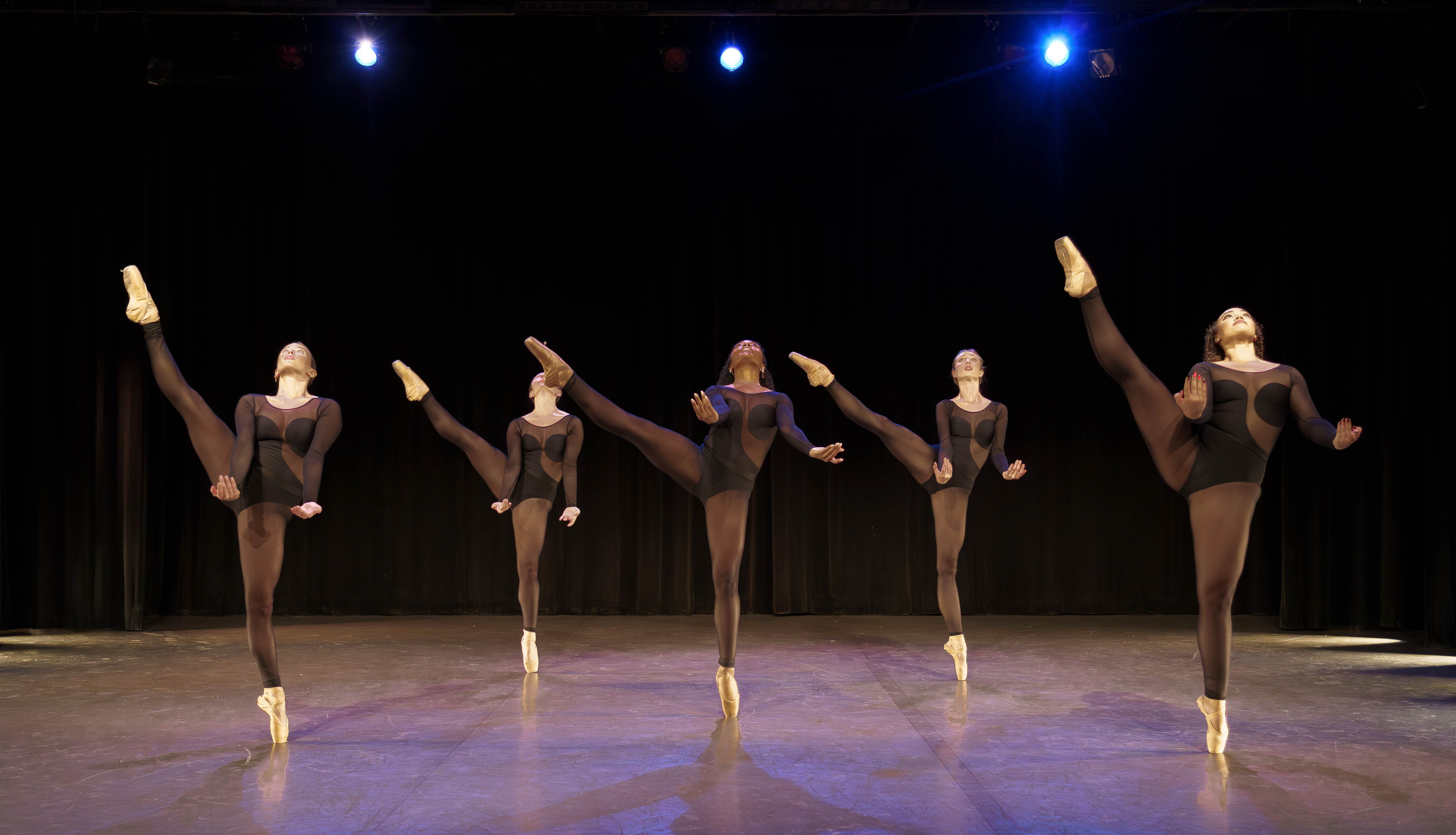 group of dancers in all black